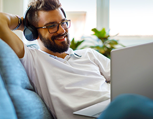 Man with headphones on computer