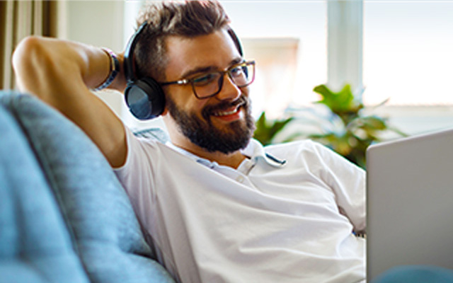 Man with headphones on computer